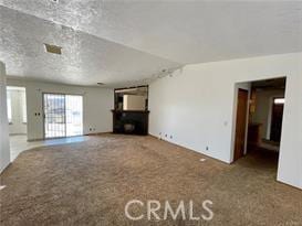 unfurnished living room with lofted ceiling and carpet