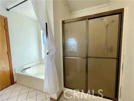 bathroom with crown molding and separate shower and tub