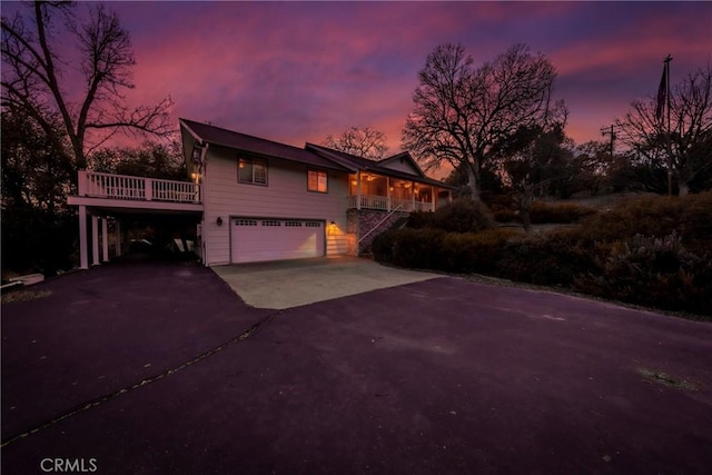 view of front of property featuring a carport, driveway, and a porch