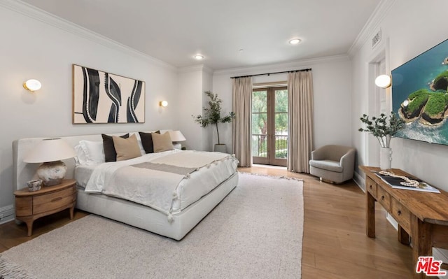 bedroom featuring hardwood / wood-style flooring, crown molding, access to outside, and french doors