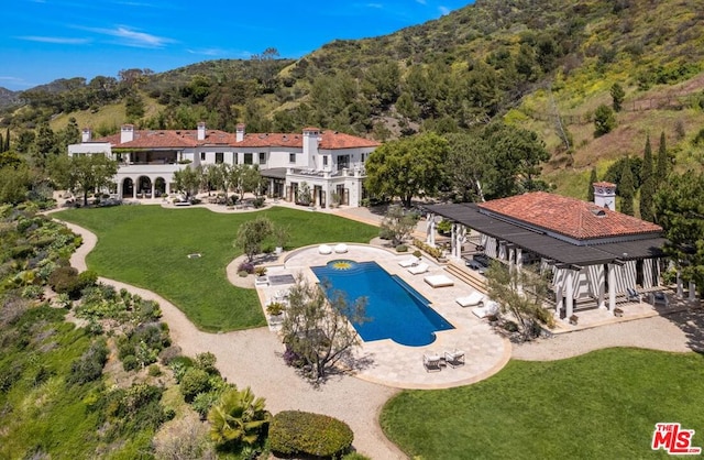 view of swimming pool with a lawn and a patio