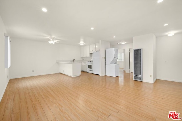 unfurnished living room with sink and light wood-type flooring