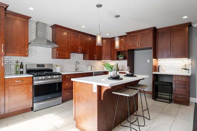 kitchen featuring wall chimney exhaust hood, backsplash, sink, a kitchen island, and stainless steel range with gas cooktop