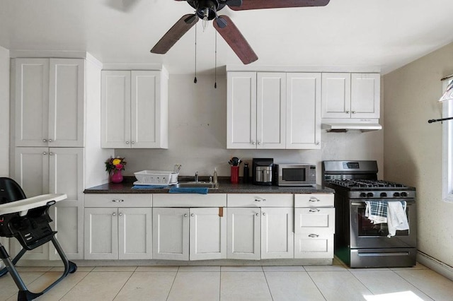 kitchen with white cabinetry, appliances with stainless steel finishes, sink, light tile floors, and ceiling fan