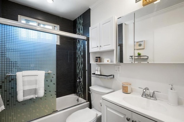 full bathroom with crown molding, toilet, bath / shower combo with glass door, and large vanity