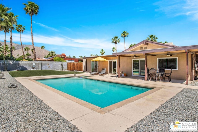 view of pool with ceiling fan and a patio