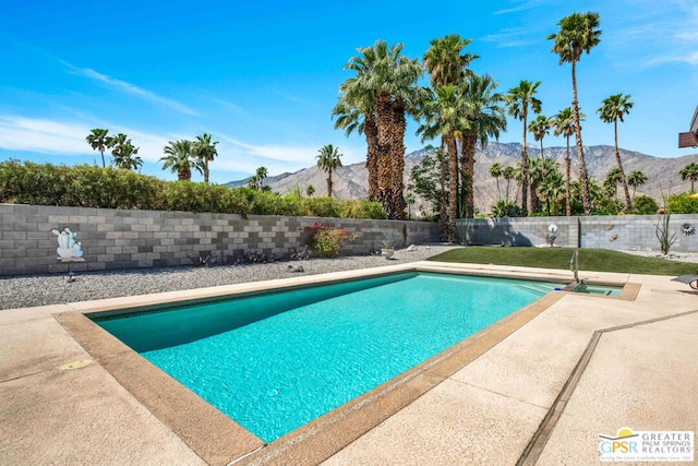 view of swimming pool featuring a mountain view and a patio area