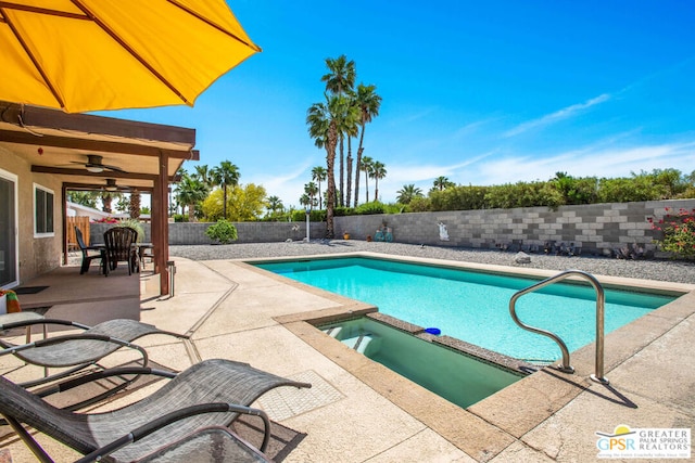 view of pool with ceiling fan, a patio area, and an in ground hot tub