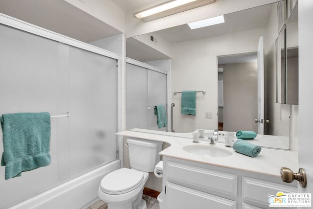 full bathroom featuring toilet, vanity, and bath / shower combo with glass door