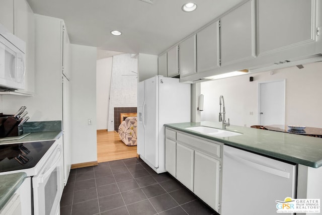 kitchen with white cabinetry, sink, and white appliances