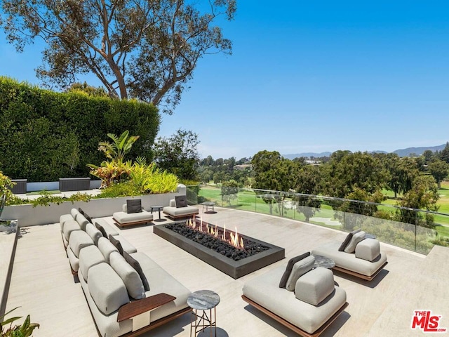 view of patio / terrace featuring an outdoor living space with a fire pit