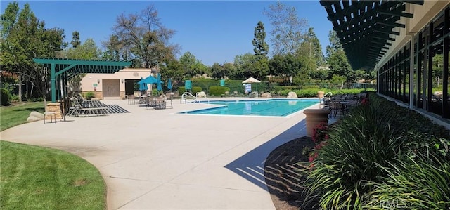 community pool with a patio area and a pergola