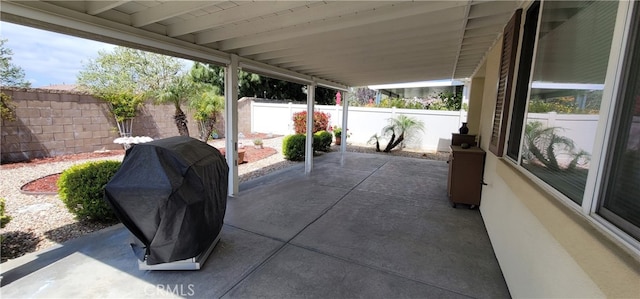 view of patio with a fenced backyard and a grill