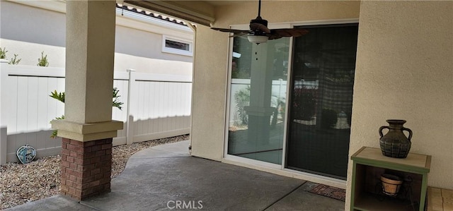 view of patio / terrace with a ceiling fan and fence