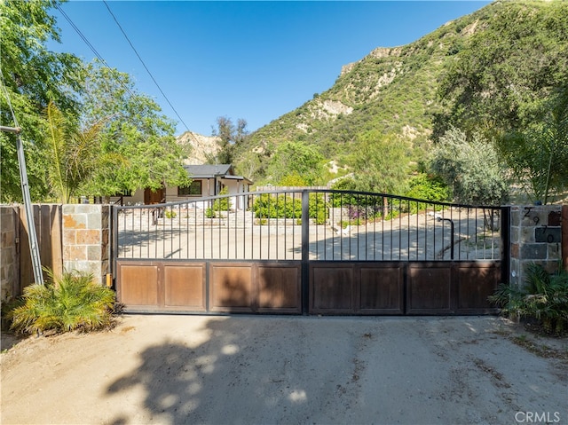 view of gate with a mountain view