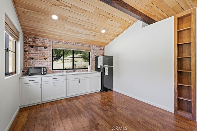 kitchen featuring vaulted ceiling with beams, dark hardwood / wood-style flooring, black appliances, brick wall, and wooden ceiling