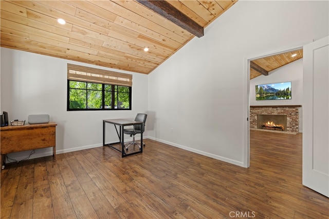 sitting room with wood-type flooring, vaulted ceiling with beams, a brick fireplace, and wood ceiling