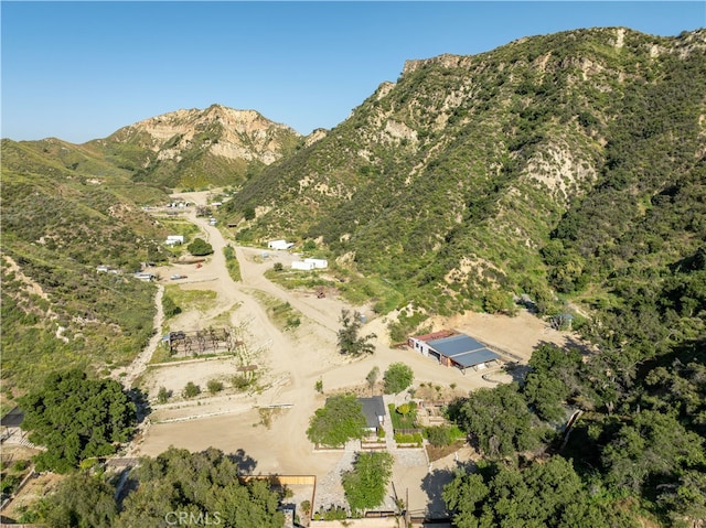 birds eye view of property with a mountain view