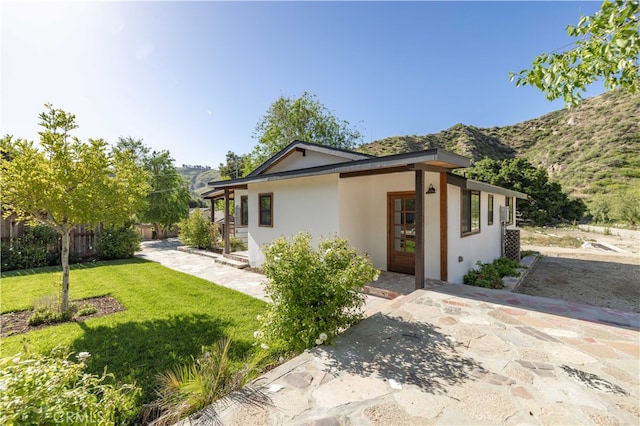 view of front facade with a mountain view and a front lawn