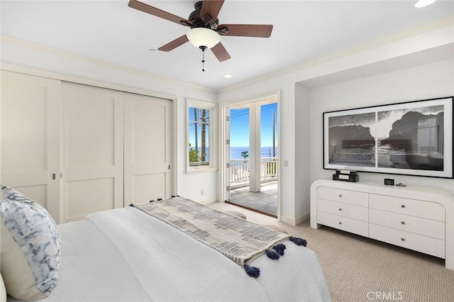 bedroom with baseboards, light colored carpet, ceiling fan, access to outside, and a closet