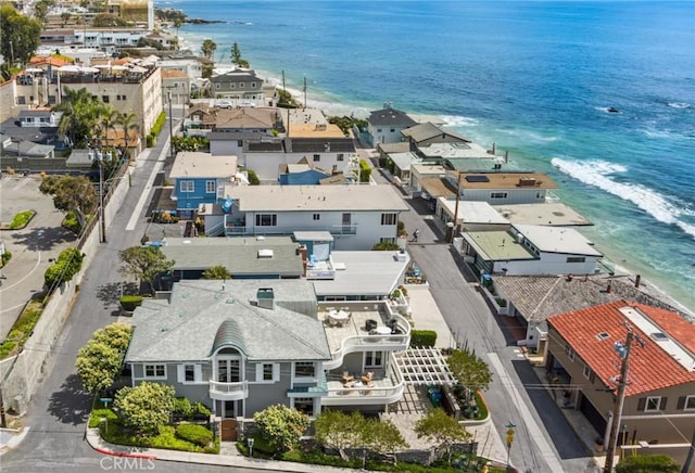 drone / aerial view with a water view, a residential view, and a beach view