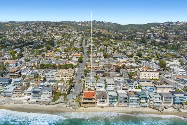 bird's eye view featuring a water view and a beach view