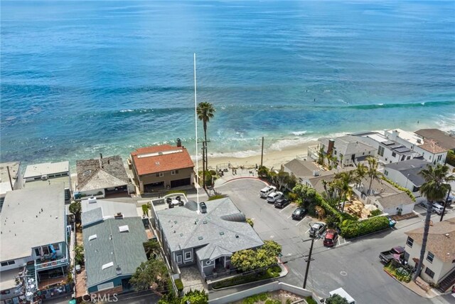 birds eye view of property featuring a water view and a view of the beach