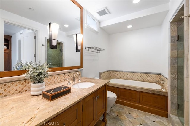 bathroom with a garden tub, recessed lighting, vanity, visible vents, and tasteful backsplash