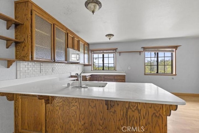 kitchen with kitchen peninsula, a wealth of natural light, and sink