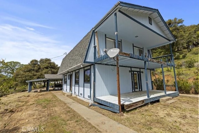 rear view of property with a balcony