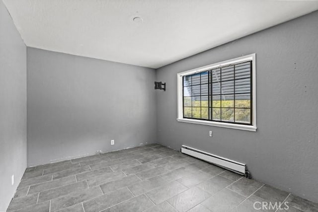 empty room with a baseboard heating unit