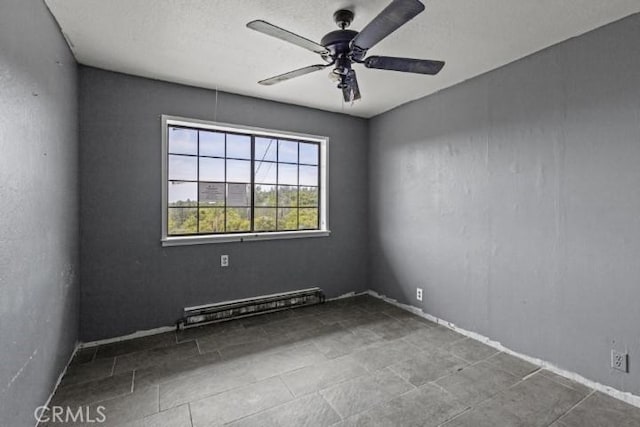 spare room featuring ceiling fan and a baseboard heating unit