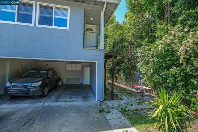 exterior space featuring a carport and a balcony