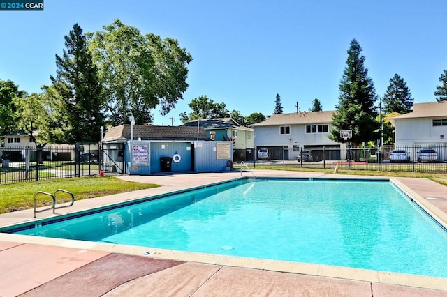 view of pool with a yard