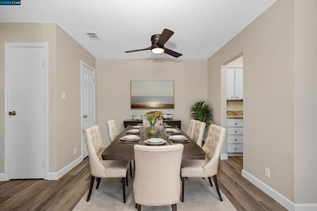 dining space with light hardwood / wood-style flooring and ceiling fan