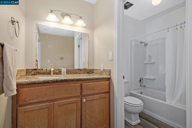 full bathroom with shower / tub combination, vanity, wood-type flooring, and toilet