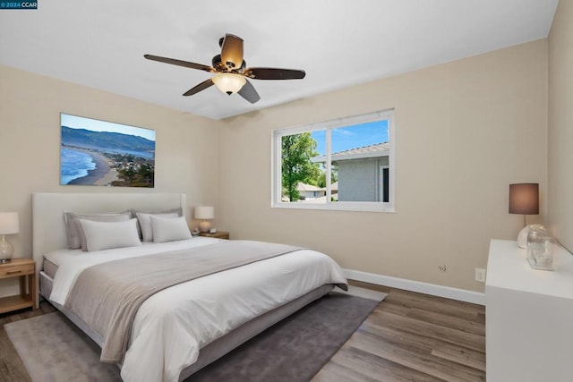 bedroom with ceiling fan and hardwood / wood-style floors