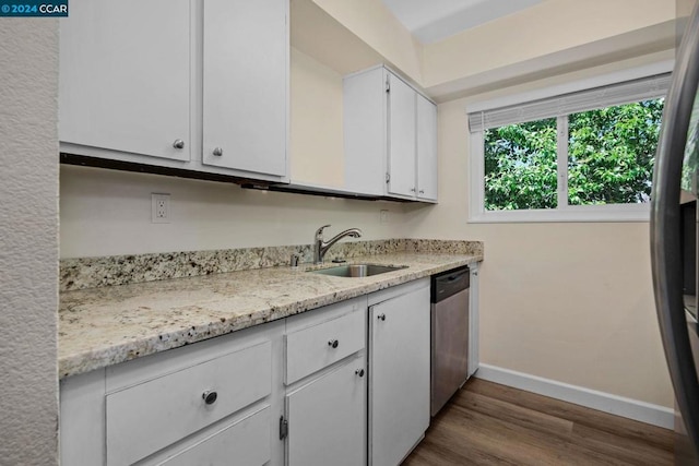 kitchen featuring white cabinets, sink, light wood-type flooring, light stone countertops, and dishwasher