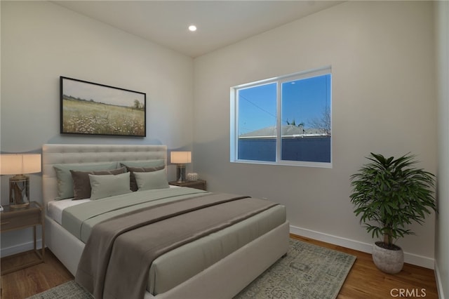 bedroom with recessed lighting, baseboards, and wood finished floors