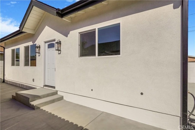 doorway to property with stucco siding