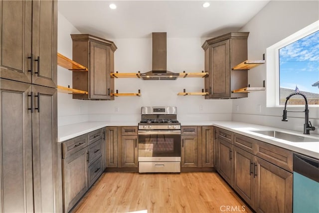 kitchen featuring extractor fan, stainless steel gas range oven, open shelves, and a sink