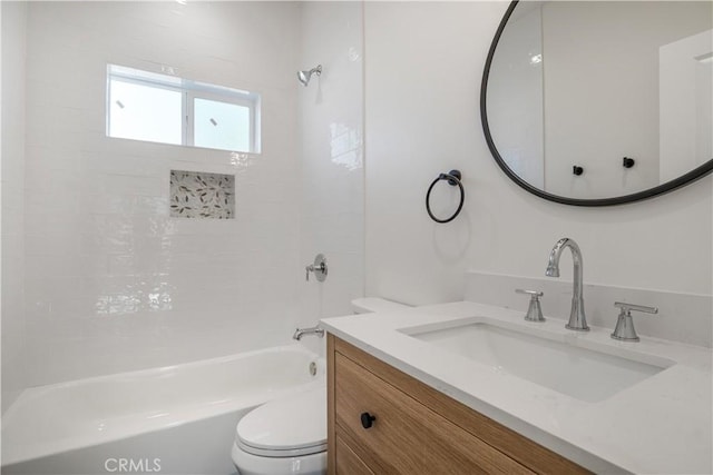 bathroom featuring toilet, tub / shower combination, and vanity