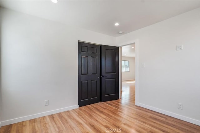 unfurnished bedroom featuring recessed lighting, baseboards, and light wood finished floors