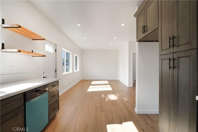 kitchen featuring light wood-style floors, open shelves, dishwasher, and light countertops