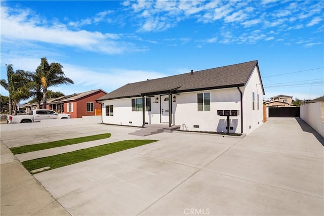 view of front of house featuring crawl space, fence, and stucco siding