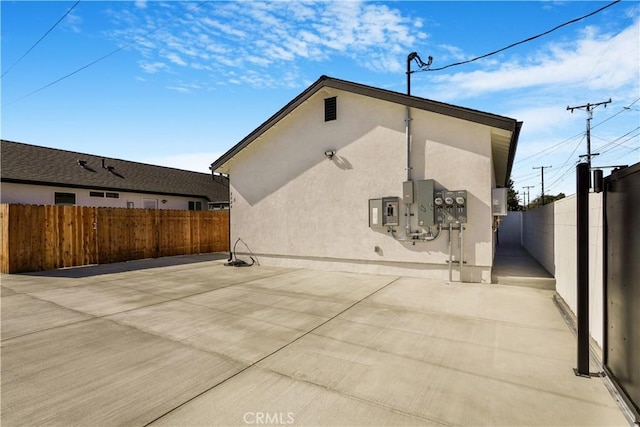 view of property exterior with a patio area, a fenced backyard, and stucco siding