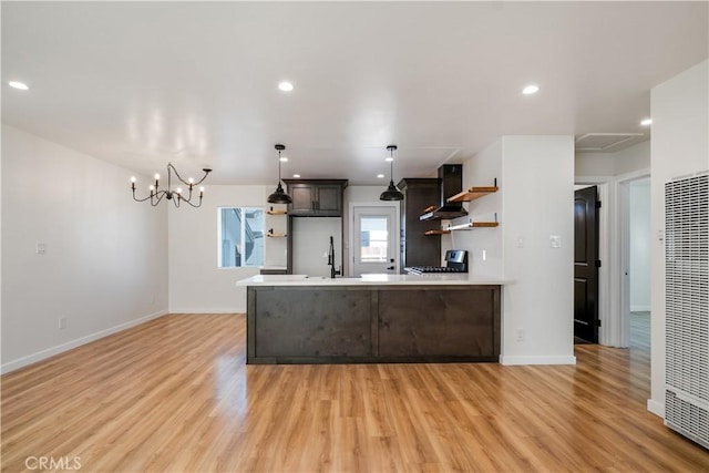 kitchen with open shelves, light wood finished floors, a peninsula, and light countertops