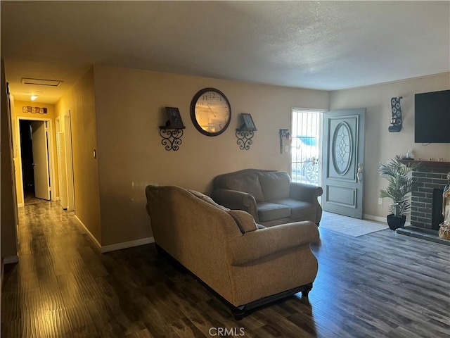 living room with a fireplace and dark hardwood / wood-style floors