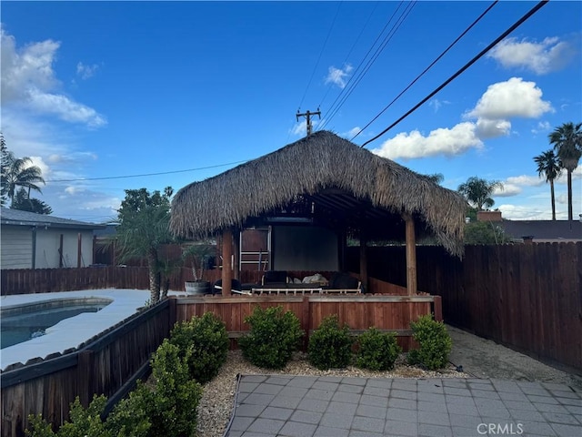 rear view of house featuring a fenced in pool