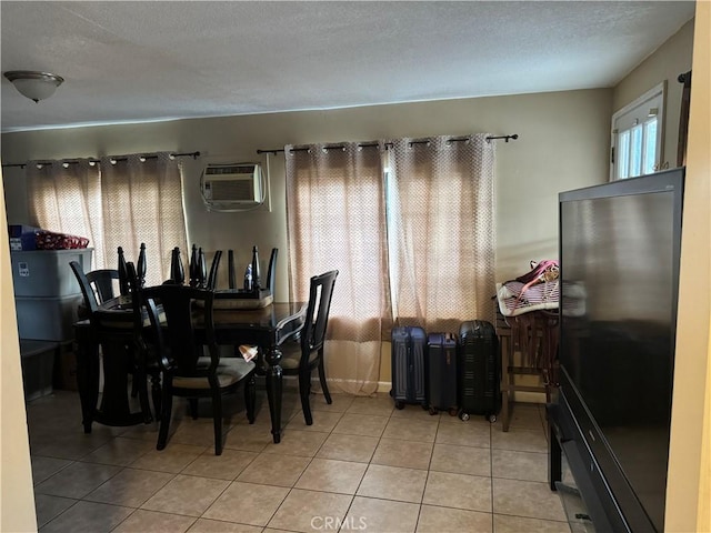 tiled dining room featuring an AC wall unit